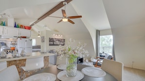 A modern kitchen with white cabinets, a wooden ceiling, and a dining area with a round table and chairs. - Mariposa Home: Furnished Patio & Sierra Mtn Views (Mariposa)