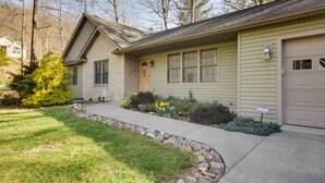 A two-story house with a front yard, a driveway, and a garage.