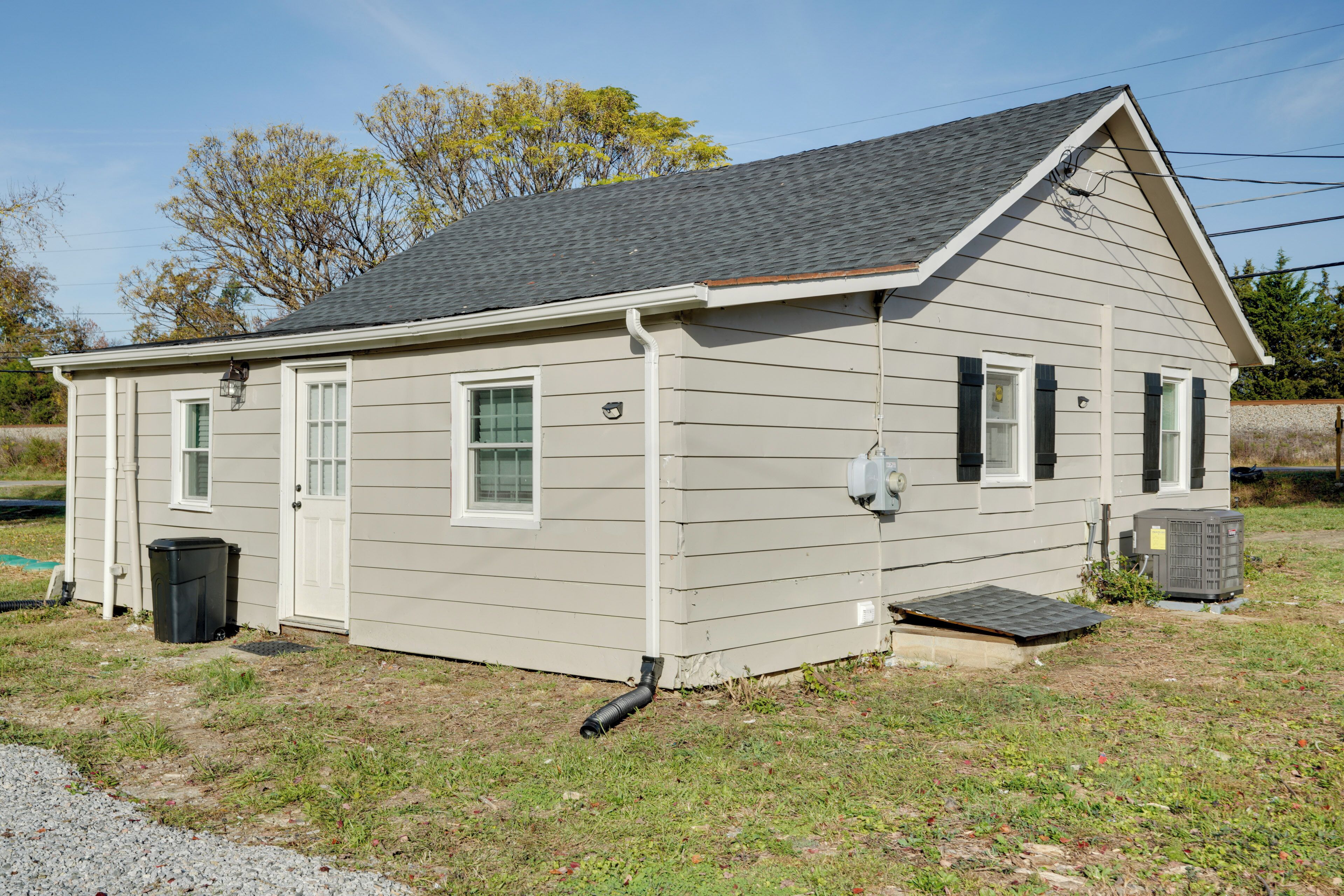 A single-story house with a gabled roof, a front door, and a small porch.