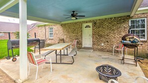 A covered patio with a table and chairs, a ceiling fan, and a grill. - Homey Greenwood Getaway w/ Patio & Backyard (Greenwood)