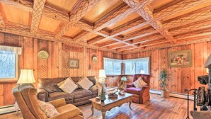 A cozy wooden interior with a leather sofa, a coffee table, and a fireplace. - Old Time Catskill Mtn Retreat, Handcrafted Cabin! (East Durham)