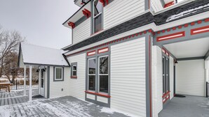 A two-story house with a covered porch and a deck. - Charming Stevensville Home w/ Open Yard! (Stevensville)