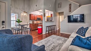 A spacious living area with a sofa, a dining table, and a kitchen in the background. - 1 Block to Boat Ramp: Monkey Island Home (Afton)