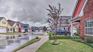 A residential street with houses, a sidewalk, and a blue car parked on the street. - 1 Block to Boat Ramp: Monkey Island Home (Afton)