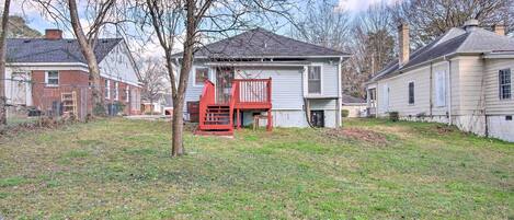 A residential area with houses, a red deck, and a grassy yard.