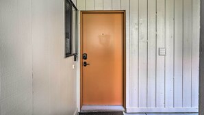 A closed wooden door with a peephole, a small window with a shutter, and a doormat at the entrance. - All-season Sun Valley Retreat w/ Deck & Grill (Sun Valley)