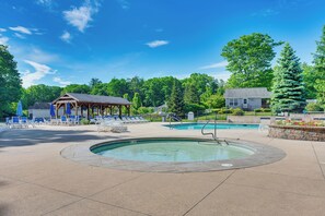 A pool area with lounge chairs and a gazebo. - Charming Coastal Cottage w/ Pool Access! (Wells)