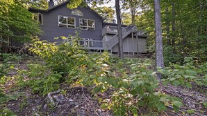 A house with a deck and a staircase leading to a second level. - Resort-style Harbor Springs Home Near Ski Resort! (Harbor Springs)