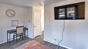 A room with a desk, chair, clock, and a window with a view. - Family-friendly Rockford Home w/ Private Yard! (Rockford)