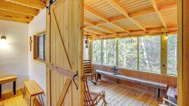 A wooden cabin with a porch, benches, rocking chairs, and a fan. - Secluded Tallassee Cabin w/ Fire Pit & Porch! (Tallassee)