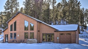 A modern two-story building with large windows and a garage, surrounded by snow and trees. - 'hakuna Matata Cabin' - 11 Mi to Mt Rushmore! (Rapid City)