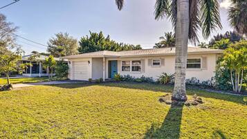 A single-story house with a front porch, a garage, and a well-maintained lawn.