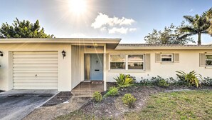 A single-story house with a garage, a front door, and a small porch. - Punta Gorda Home With Backyard ~ 1 Mile to Dtwn! (Punta Gorda)
