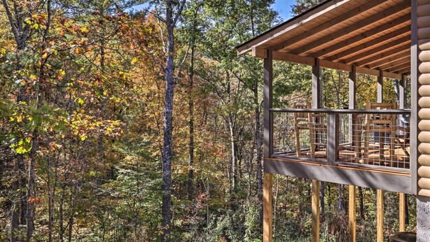 A wooden cabin with a balcony overlooking a forested area. - Pigeon Forge Cabin w/ Hot Tub: 1 Mi to Parkway (Pigeon Forge)