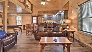 A spacious living area with a pool table, leather sofa, and a dining table. - Pigeon Forge Cabin w/ Hot Tub: 1 Mi to Parkway (Pigeon Forge)