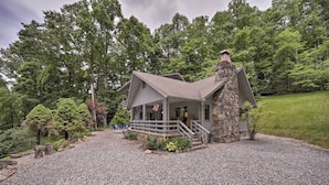 A stone cabin with a porch and a chimney, surrounded by a gravel driveway and lush greenery. - Mountain Escape w/ Hiking ~ 5 Mi to Bryson City! (Bryson City)