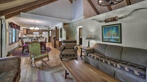 A spacious living room with wooden floors, a dining area, and a kitchen. - Mountain Escape w/ Hiking ~ 5 Mi to Bryson City! (Bryson City)
