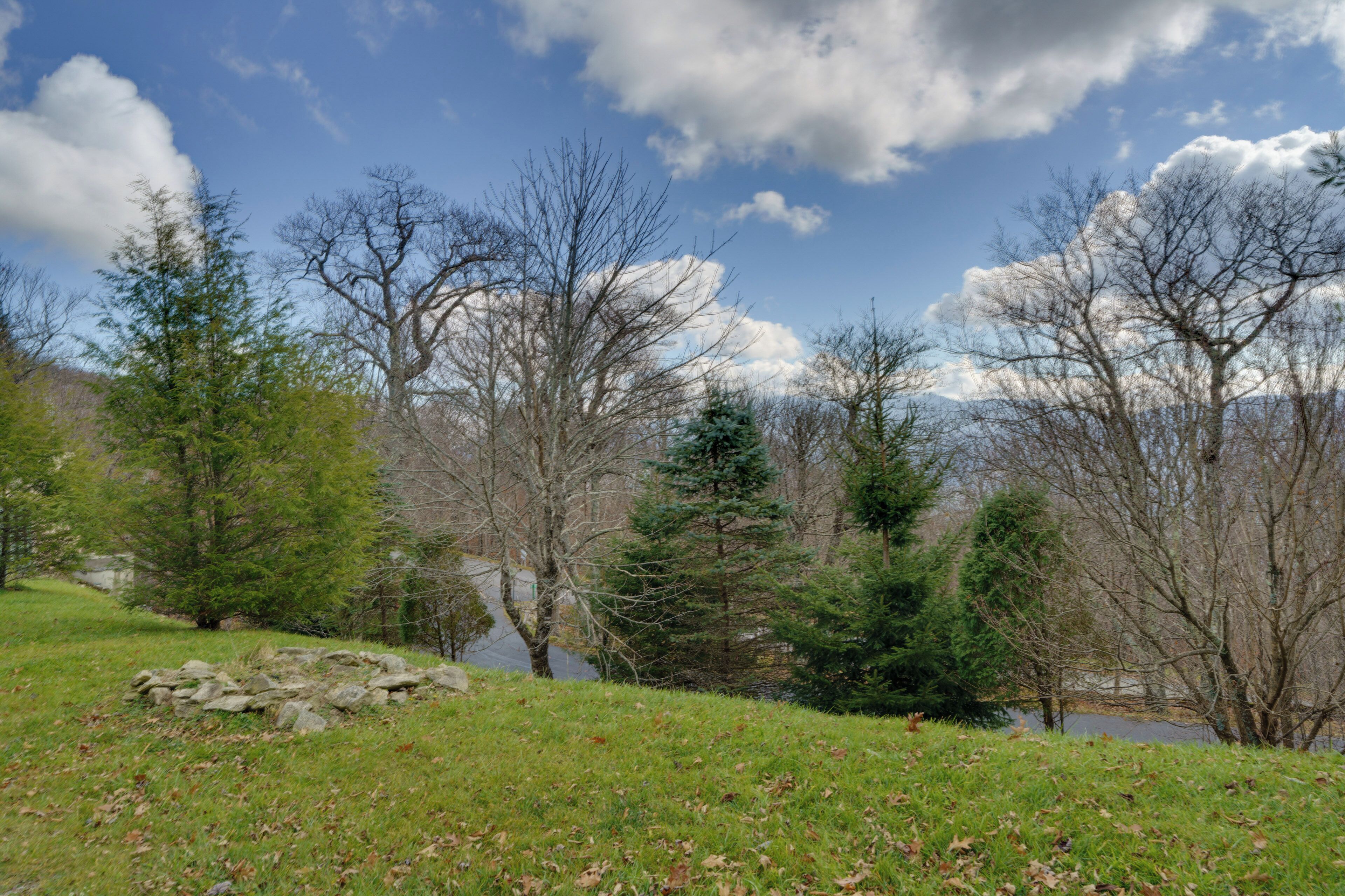 A natural landscape with a body of water, trees, and a stone structure.