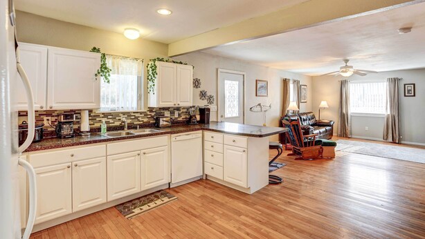 A spacious kitchen with white cabinets, a wooden countertop, and a built-in dishwasher. - Pierre Vacation Rental w/ Grill & Fenced Yard (Pierre)