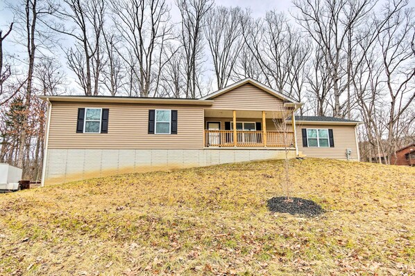 A two-story house with a front porch and a small attached garage.