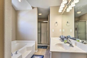 A modern bathroom with a large bathtub, a walk-in shower, and a vanity with two sinks. - Lakefront Camdenton Home w/ Fire Pit & Grill! (Camdenton)