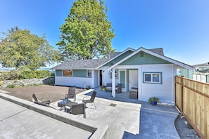 A single-story house with a patio, outdoor seating, and a fenced yard. - Waterfront Home ~ 6 Mi to Olympic National Park! (Port Angeles)