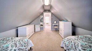 A bedroom with two beds, a desk, a chair, and a dresser. - Family-friendly Wildwood Apt: Bike to Beach! (Wildwood)