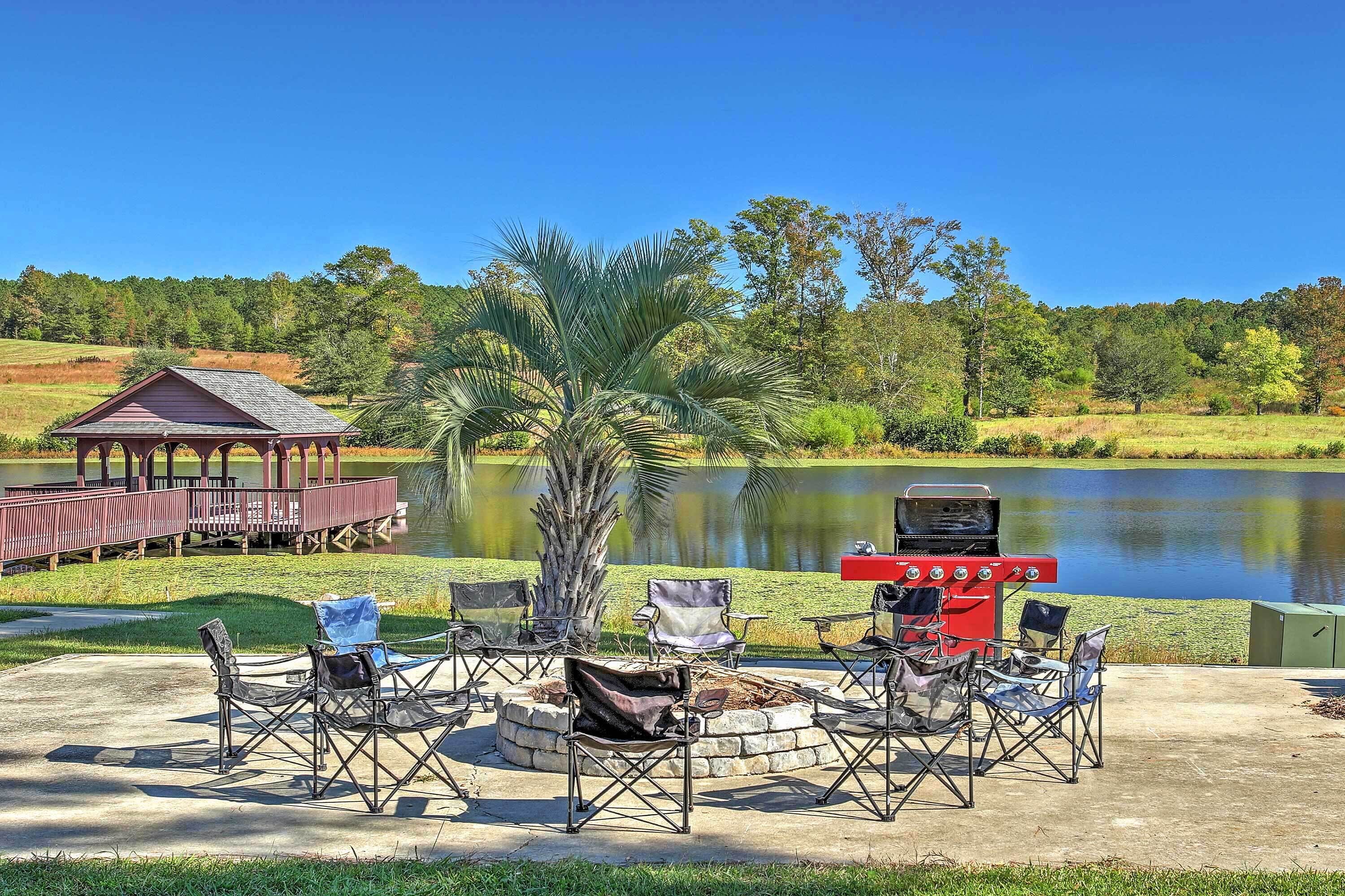 A lakeside patio with outdoor seating, a barbecue grill, and a gazebo.