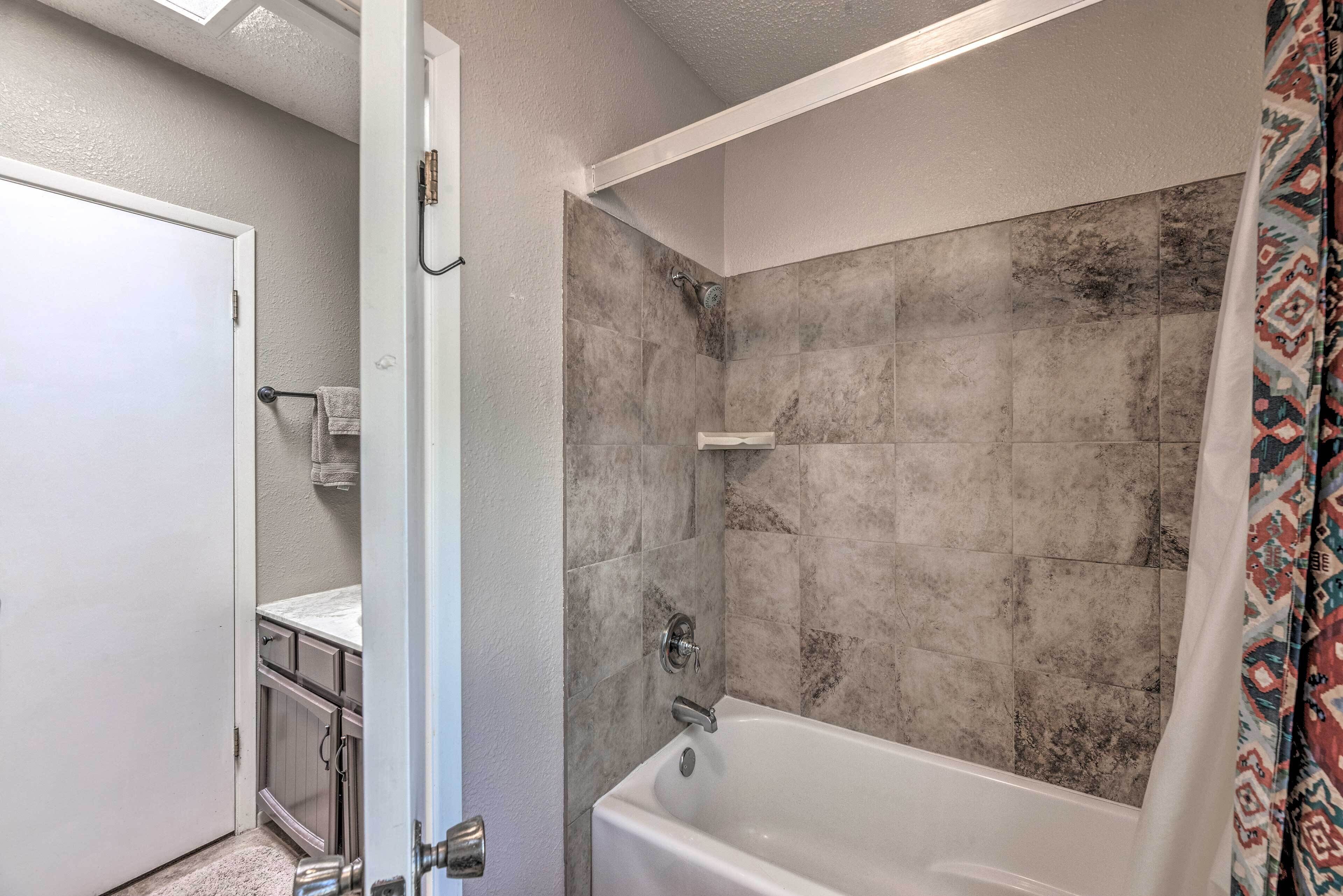 A bathroom with a bathtub, a shower, and a toilet.