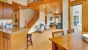 A spacious kitchen with wooden cabinets, a granite countertop, and a built-in stove. - Pet-friendly Hancock Home on the Delaware River! (Hancock)