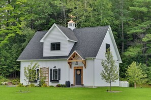 A white two-story house with a dark roof, a front porch, and a small attached garage. - Cozy Campton Cottage < 1 Mi to Owls Nest Resort! (Campton)