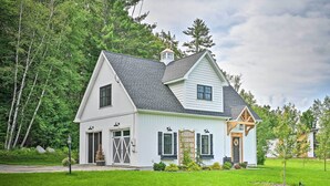 A white two-story house with a gabled roof, a front porch, and a garage. - Cozy Campton Cottage < 1 Mi to Owls Nest Resort! (Campton)