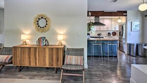 A modern kitchen with a central island, bar stools, and a dining area with a wooden table and chairs. - San Diego Gem w/ Private Hot Tub, Close to Dtwn! (San Diego)