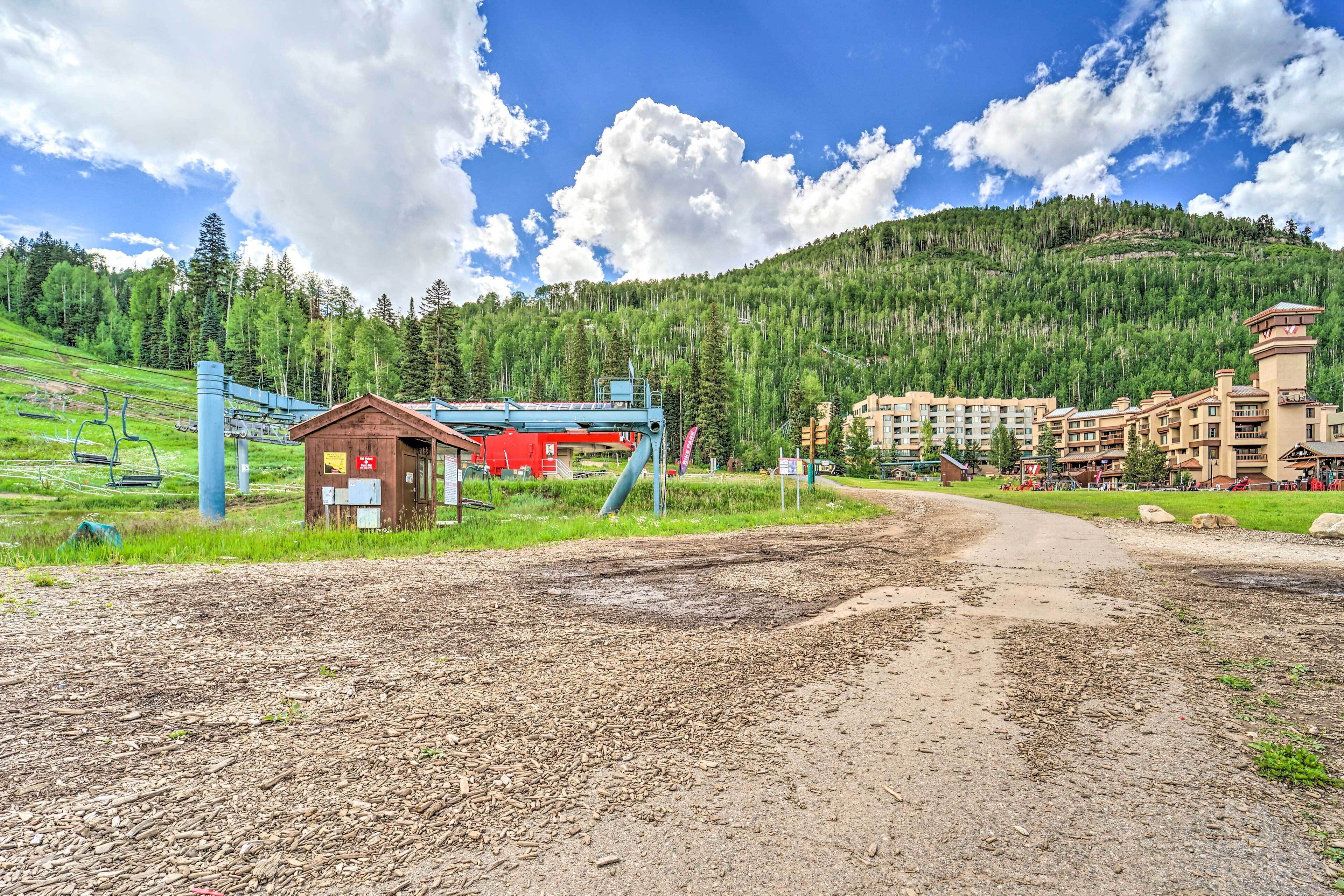 A ski resort with a ski lift, a lodge, and a building complex.