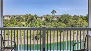 A balcony with a view of a golf course and residential buildings. - Shuttle to Ocean! North Myrtle Beach Retreat (North Myrtle Beach)