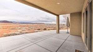 A covered outdoor area with a view of a desert landscape. - Modern Apartment w/ Beautiful Mountain Views! (St. George)