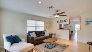 A living room with a sofa, armchair, coffee table, and a ceiling fan. - 2 Mi to Bonita Beach: Bbq-ready Townhome! (Bonita Springs)