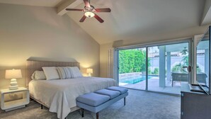 A bedroom with a bed, bench, nightstands, and a ceiling fan. - Palm Desert Retreat w/ Private Pool, Near Golf! (Palm Desert)