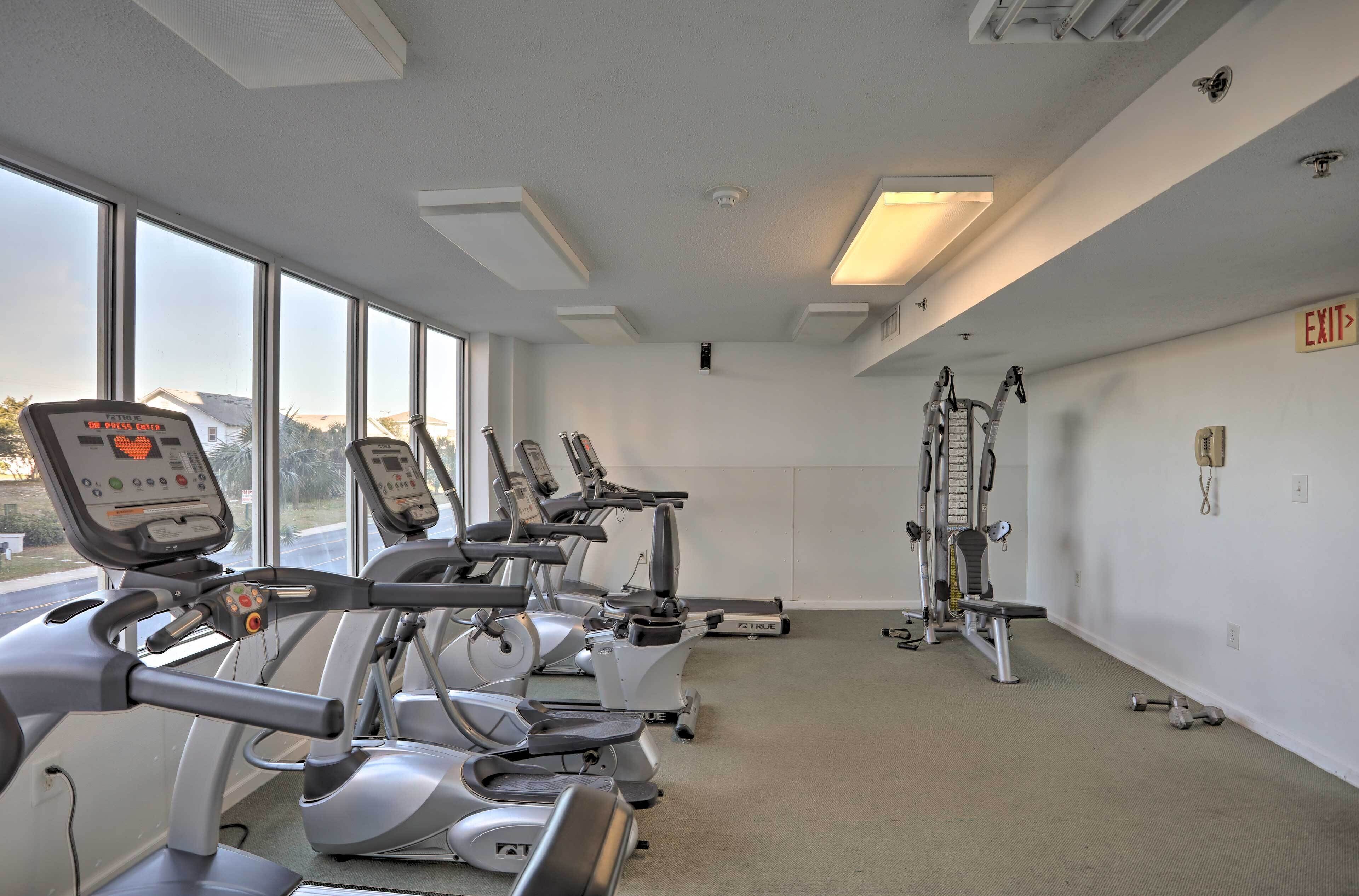 A gym with treadmills, elliptical machines, and a stair climber.