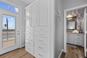 A bathroom with white cabinetry, a large mirror, and a patterned shower curtain. - Boat Dock Access: Waterfront Freeport Home! (Freeport)