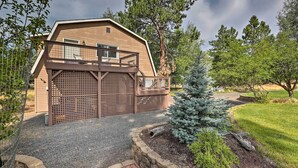 A two-story building with a wooden exterior and a balcony. - Upscale Bend Barn w/ Deck - Close to Trails! (Bend)