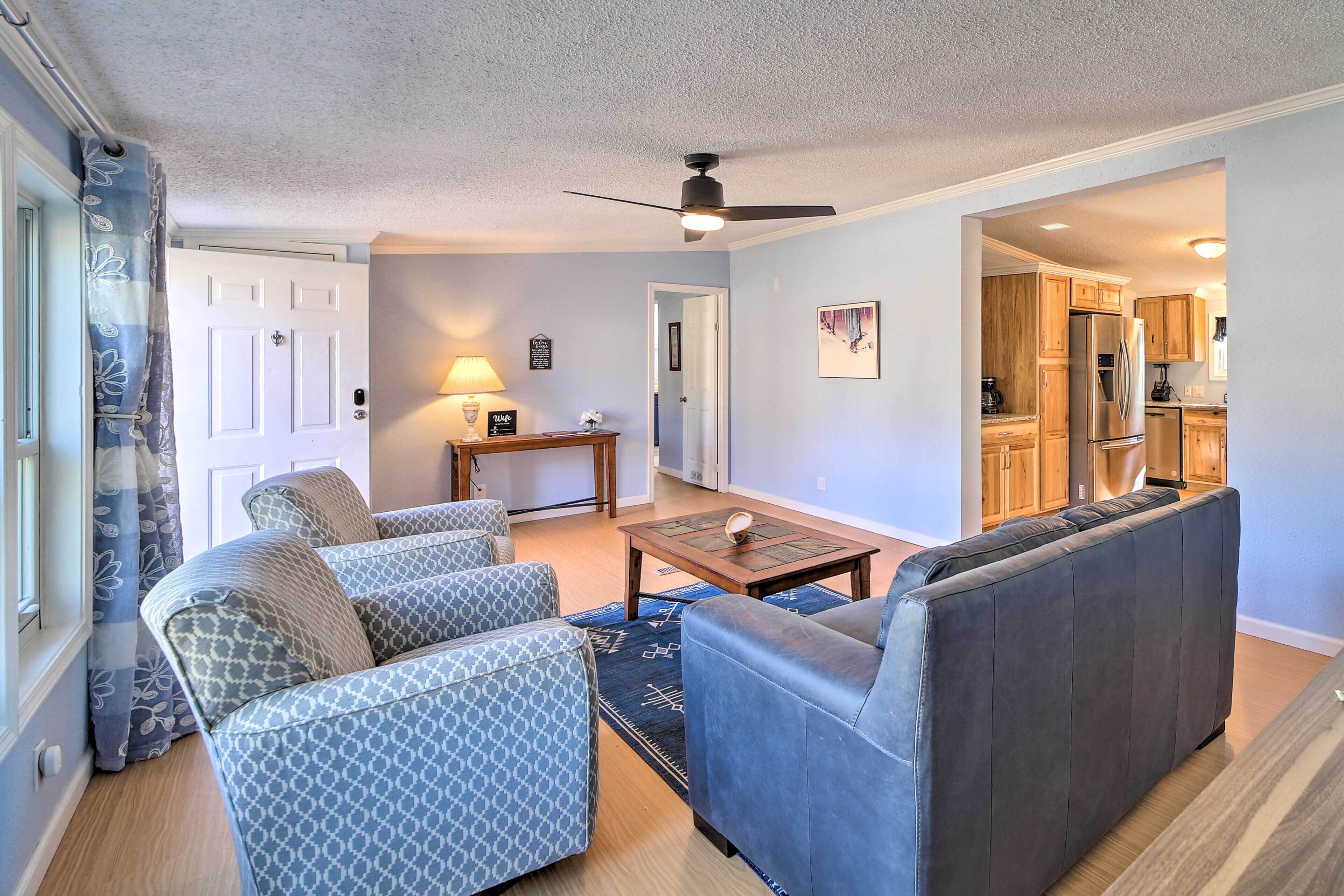 A living room with a sofa set, a coffee table, and a ceiling fan.