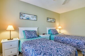 A bedroom with two beds, each with a matching headboard and pillow, and a nightstand with a lamp. There are two wall-mounted artworks above the beds. - Close to Rehoboth & Dewey w/ Access to 3 Pools! (Rehoboth Beach)