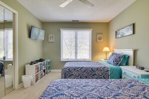 A bedroom with two beds, a TV, a bookshelf, and a window with blinds. - Close to Rehoboth & Dewey w/ Access to 3 Pools! (Rehoboth Beach)