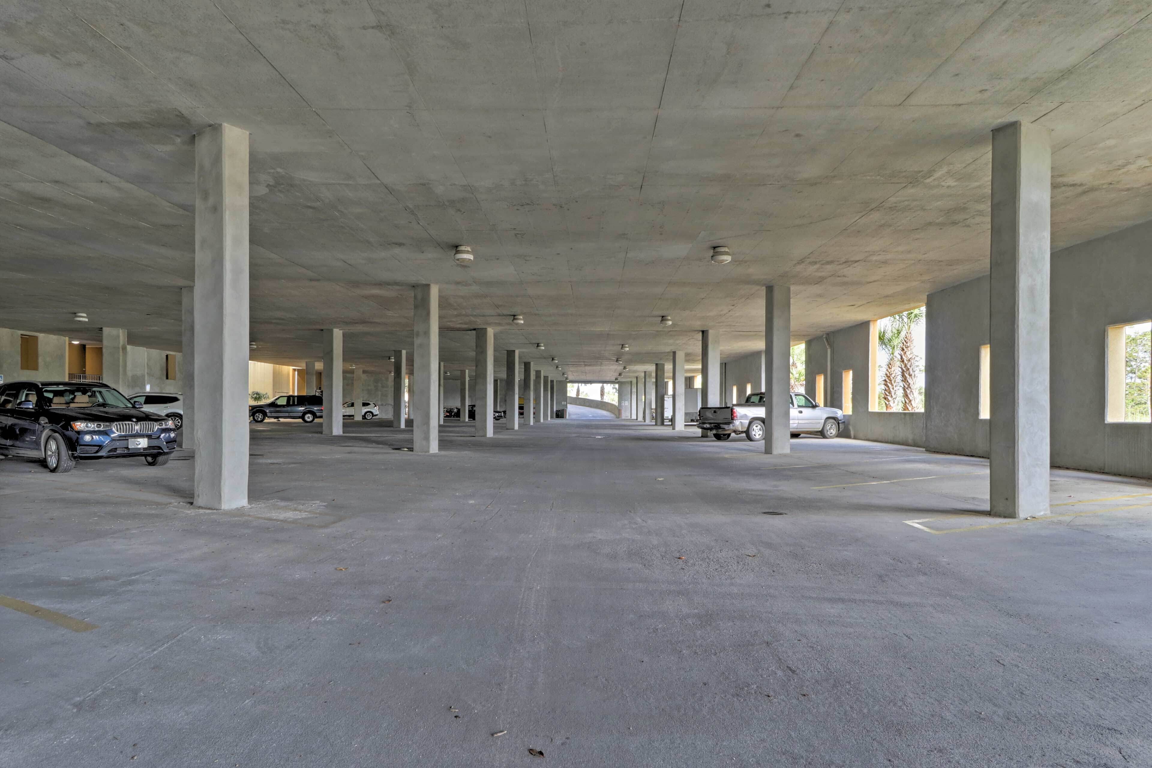 A large, open parking garage with concrete pillars and a high ceiling.