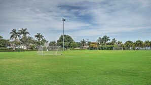 A soccer field with a goalpost, surrounded by palm trees and a clear sky. - Marco Island Retreat w/ Pool ~ 1 Mi to Beach (Marco Island)