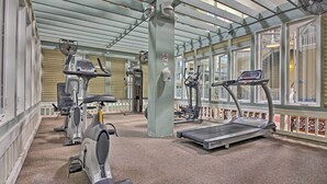 A gym with stationary bikes, treadmills, and weight machines.