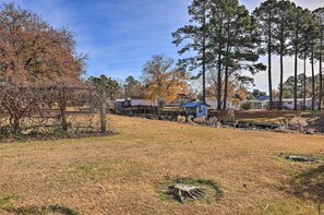 A residential area with houses, a small shed, and a grassy field. - Pet-friendly Cabin w/ Dock: Fish & Explore! (Oriental)