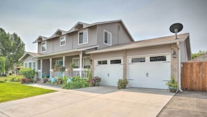 A two-story house with a front porch, a garage, and a satellite dish. - Idyllic Nampa Family Home With Hot Tub & Fire Pit! (Nampa)