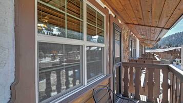 A wooden balcony with a view of a snowy mountain.